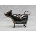 An Elizabeth II silver cow creamer, of naturalistic form, with a fly topped hinged pad,