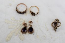 A pair of amethyst earrings, of pear shape in a yellow metal setting and post,
