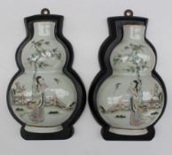 A pair of 19th century Chinese porcelain wall pockets, in the form of double gourd vases,