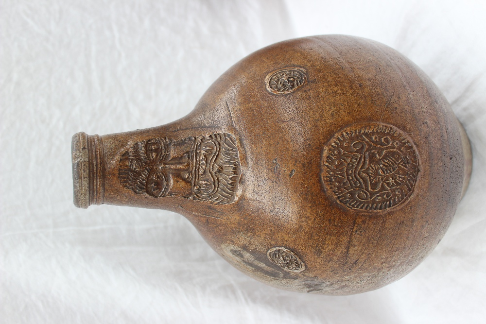 A large 18th century salt glazed Bellarmine mask jug, with a ring handle and finger marks, - Image 3 of 10