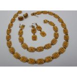 A matching yellow metal bracelet, necklace and earrings,