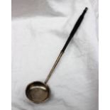 A white metal toddy ladle with makers mark for William Ferguson ladle on a turned and tapering