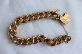 A 9ct yellow gold bracelet with textured links and padlock clasp,