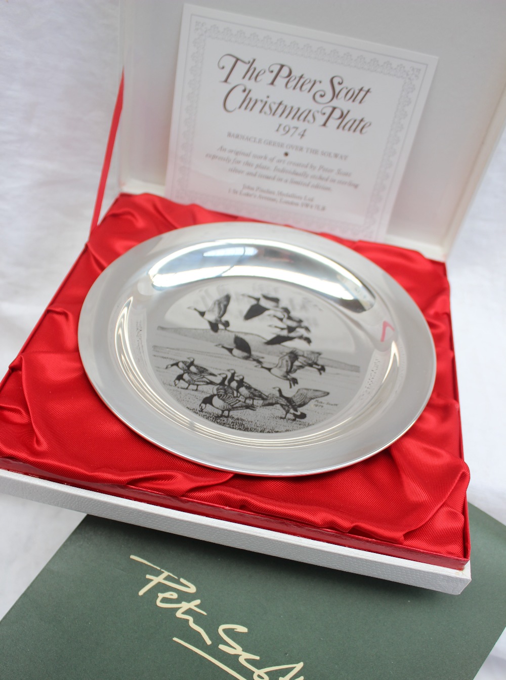An Elizabeth II silver Peter Scott Christmas Plate 1974, decorated with Barnacle geese over Solway,
