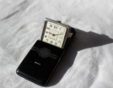 An Art Deco sliding pocket watch with black enamel and silver decoration the square dial with