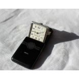 An Art Deco sliding pocket watch with black enamel and silver decoration the square dial with