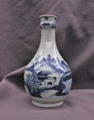 A Japanese porcelain vase decorated with dwellings on a lake,