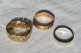 A 9ct three colour gold ring together with two other 9ct gold rings, approximately 11.