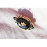 A Victorian onyx and seed pearl mourning brooch,