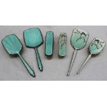 An Elizabeth II silver and enamel decorated part dressing table set, comprising a hand mirror,