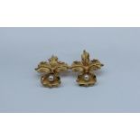 A pair of yellow metal and pearl earrings, of leaf form,