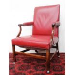 A George III mahogany library chair, with a pad upholstered back,