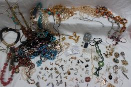 A collection of costume jewellery including necklaces, earrings, brooches,