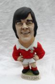 A resin Grogg of Barry John, in a red Wales jersey with a No.