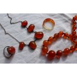 A carnelian bead necklace together with a carnelian necklace,