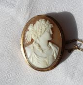 A 9ct yellow gold shell cameo, depicting a maiden with hair tied back and pearl necklace,