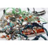 A large and extensive array of costume jewellery including bead necklaces, brooches, pendants,