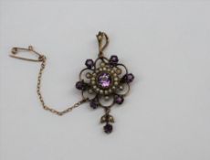 An amethyst and seed pearl pendant on a yellow metal setting CONDITION REPORT: Not
