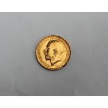 A George V gold sovereign,