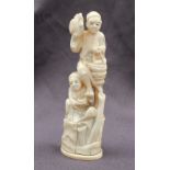 A 19th century ivory figure group depicting a figure holding a hen in his right hand and basket in