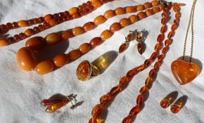 An amber bead necklace together with a faceted amber bead necklace, an oval link amber necklace,