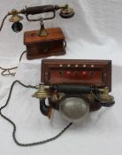 An early 20th century mahogany telephone, the bakelite and brass handset,