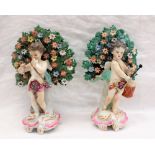 A pair of 19th century English pottery bower figures of cherubs,