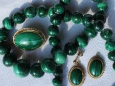 A malachite bead necklace together with a pair of malachite and 9ct gold earrings and matching
