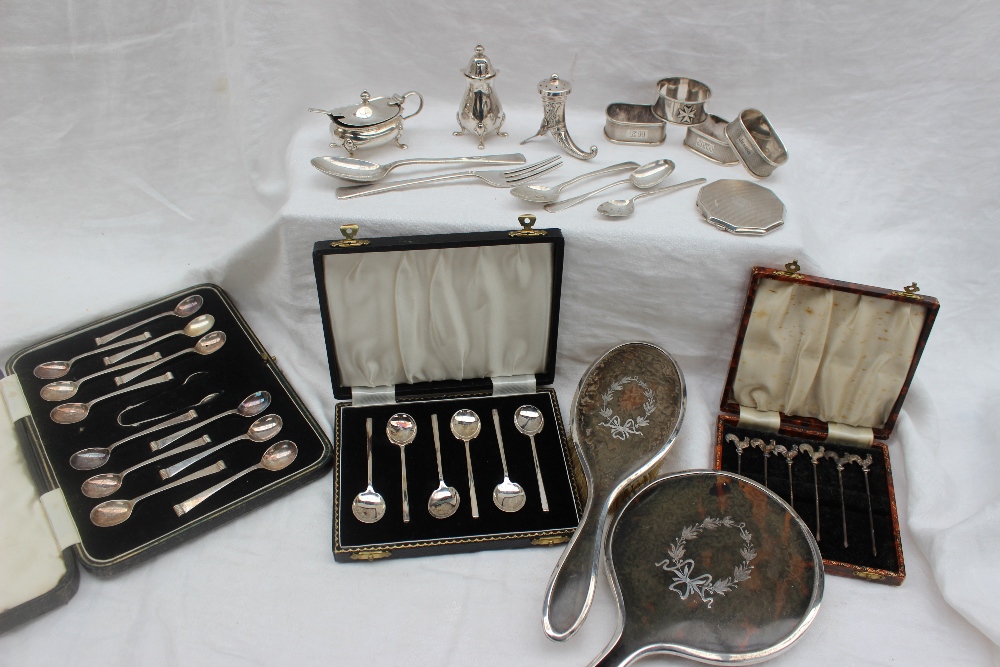A set of three George VI silver napkin rings, Birmingham, 1946 together with silver spoons,