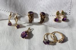 An amethyst and topaz ring set with three oval amethysts and two oval topaz to a 9ct yellow gold