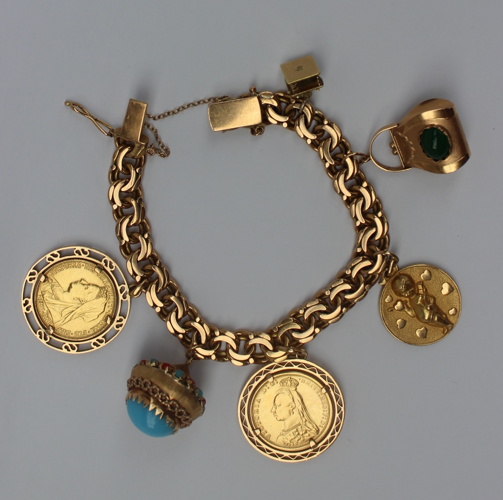 A Spanish yellow metal charm bracelet set numerous charms including a cottage, handbag, cupid,