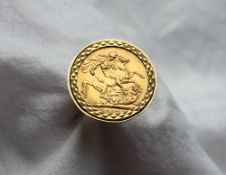 A George V gold sovereign set in a 9ct yellow gold ring setting and shank approximately 14.