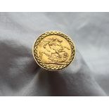 A George V gold sovereign set in a 9ct yellow gold ring setting and shank approximately 14.