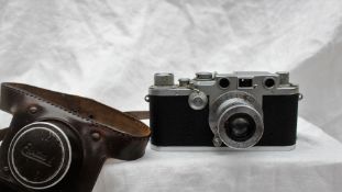 A Leica Ernst Leitz Wetzlar IIIf camera, with a black body and Leitz Elmar f=5cm 1:3,5 lens, No.