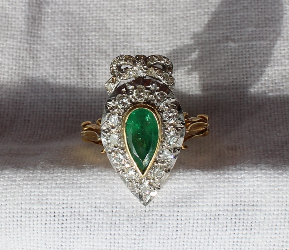An emerald and diamond ring of heart shape,