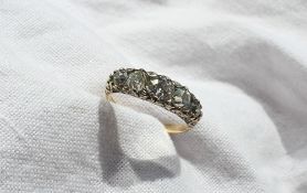 A five stone diamond ring set with graduating round old cut diamonds the central stone