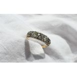 A five stone diamond ring set with graduating round old cut diamonds the central stone