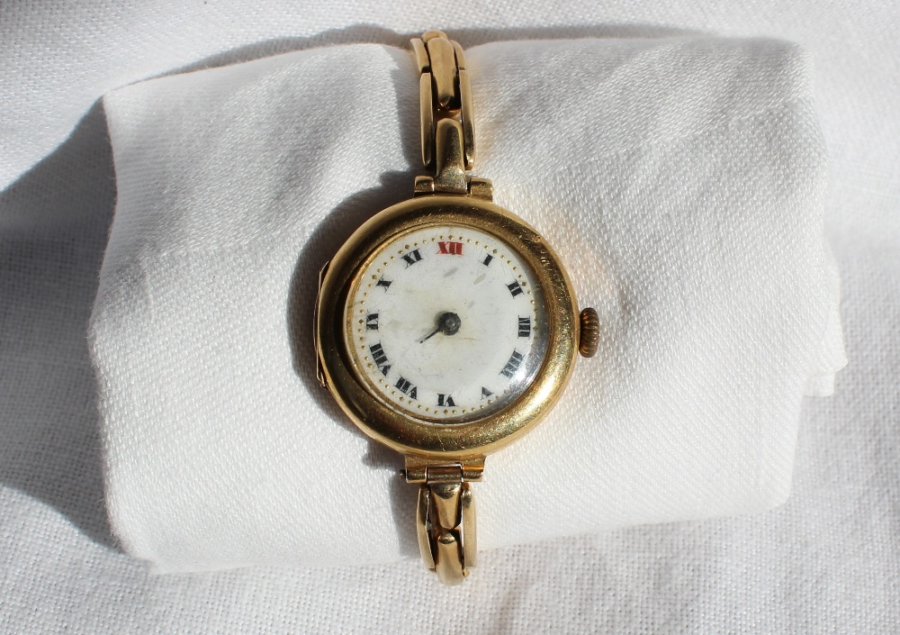 An 18ct yellow gold wristwatch with an enamel dial and Roman numerals on a yellow metal expanding - Image 2 of 3