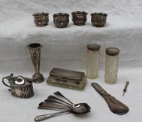 A set of four late Victorian silver table salts of circular form embossed with flowers and scrolls,