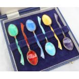 A set of six Elizabeth II silver gilt and enamel decorated coffee spoons,