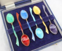 A set of six Elizabeth II silver gilt and enamel decorated coffee spoons,