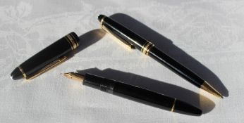 A Montblanc Meisterstuck fountain pen, with a black body and yellow 14k gold nib,