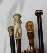 A parasol with a bone handle carved as a small boy with his hands behind his back,