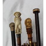 A parasol with a bone handle carved as a small boy with his hands behind his back,