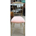 A Chiavari style solid brass chair with a pad upholstered seat