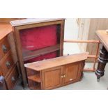 A wall mounted display cabinet together with a plate rack and a wall mounted cupboard