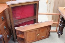 A wall mounted display cabinet together with a plate rack and a wall mounted cupboard