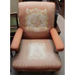 A Victorian rosewood nursing chair with tapestry upholstery on barley twist legs and arm supports