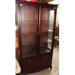 A reproduction mahogany display cabinet with a pair of glazed doors, with glazed sides,