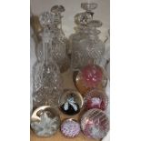 A silver topped glass decanter together with assorted glass decanters,